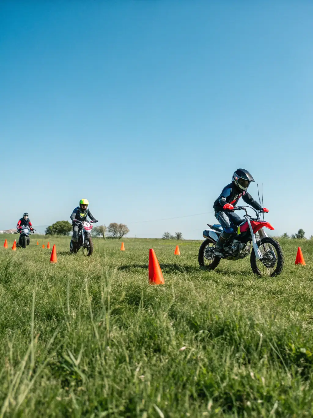 A high-quality photo of young participants practicing quad biking on a dirt track, showcasing safety gear and enthusiastic engagement.